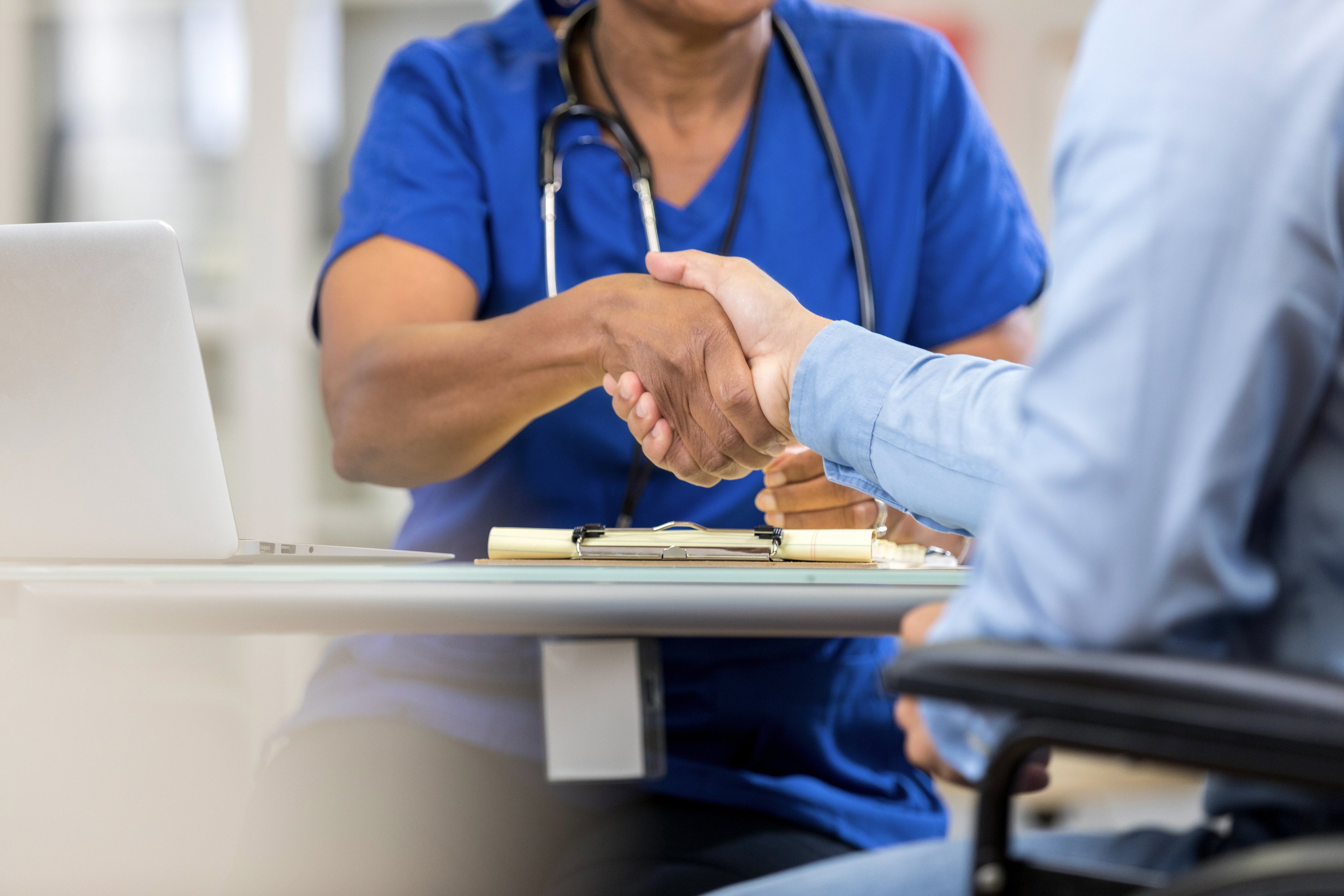 Healthcare professional greets patient