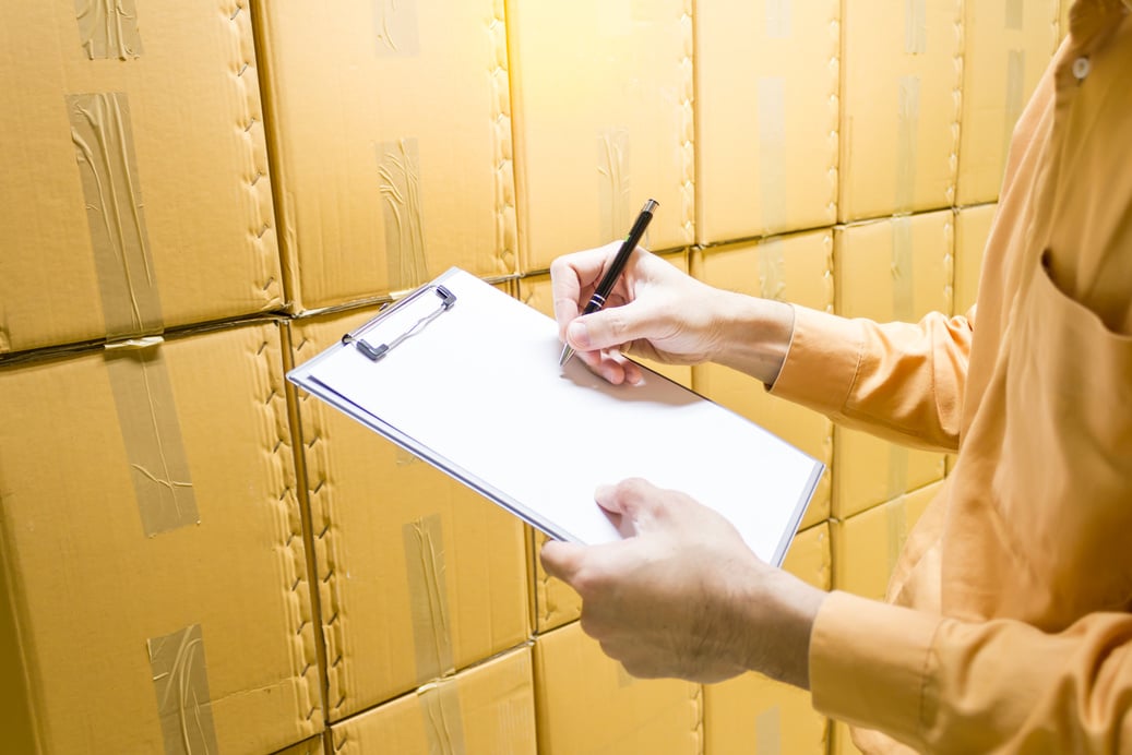 Manager checking stock products in warehouse.